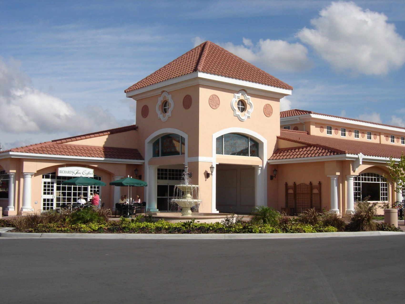 A view of the Public Library building, including a garden and coffee shop.