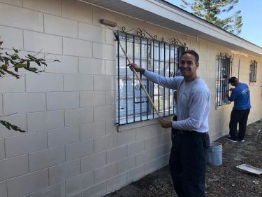 Firefighters Painting Outside of Building